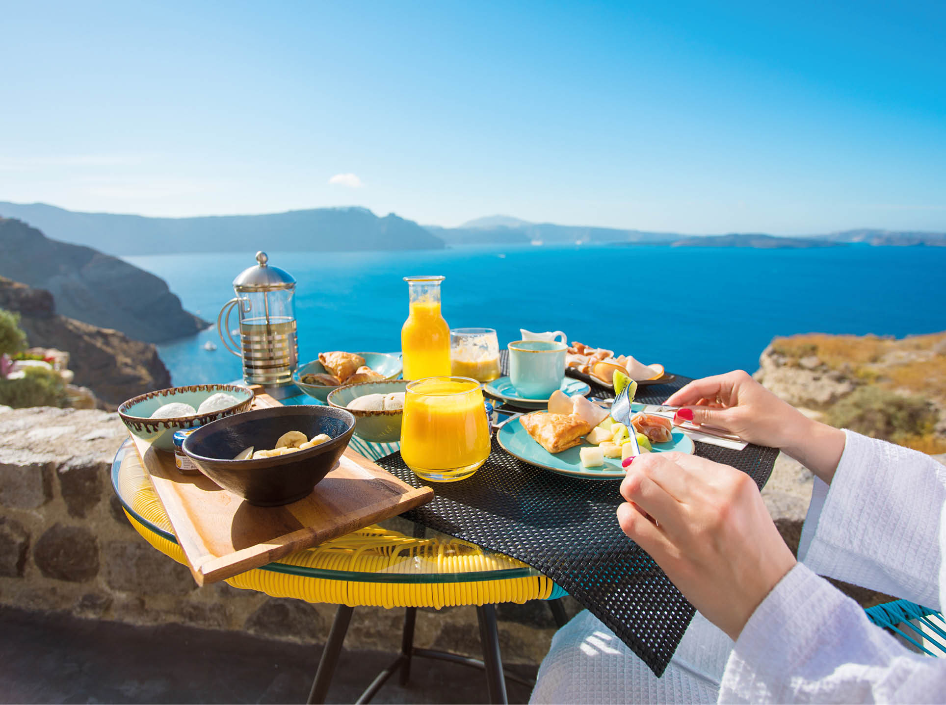 Woman having delicious breakfast in Mediterranean summer
