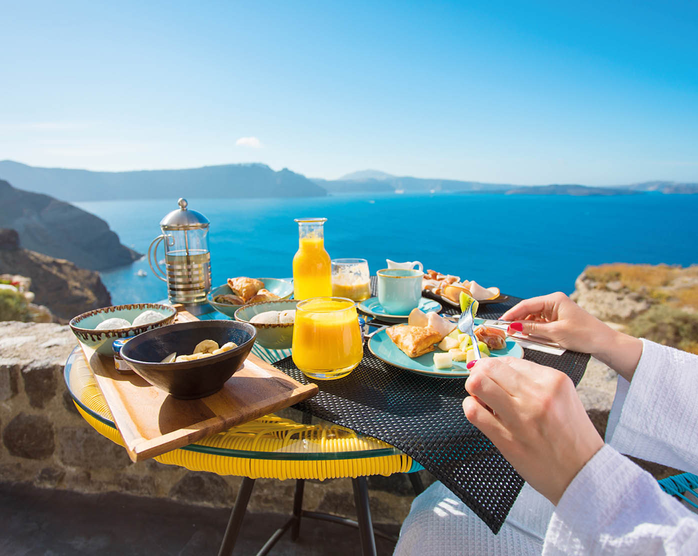 Woman having delicious breakfast in Mediterranean summer
