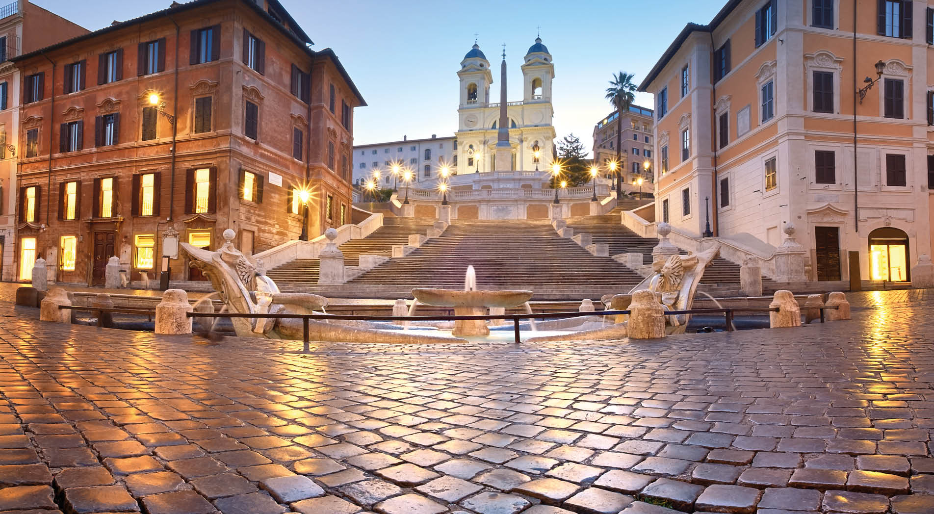 Spanish Steps and a boat-shaped fountain on Piazza di Spagna in Rome, Italy. Early morning panoramic shot after rain.