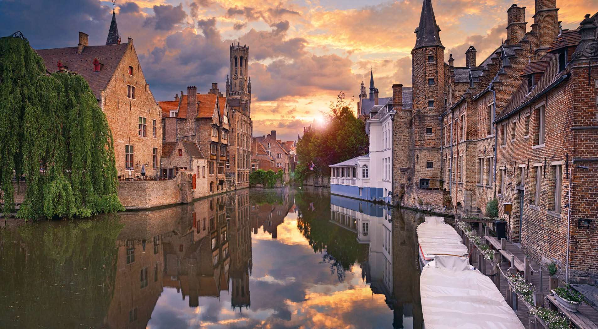Image of famous most photographed location in Bruges, Belgium during dramatic sunset.