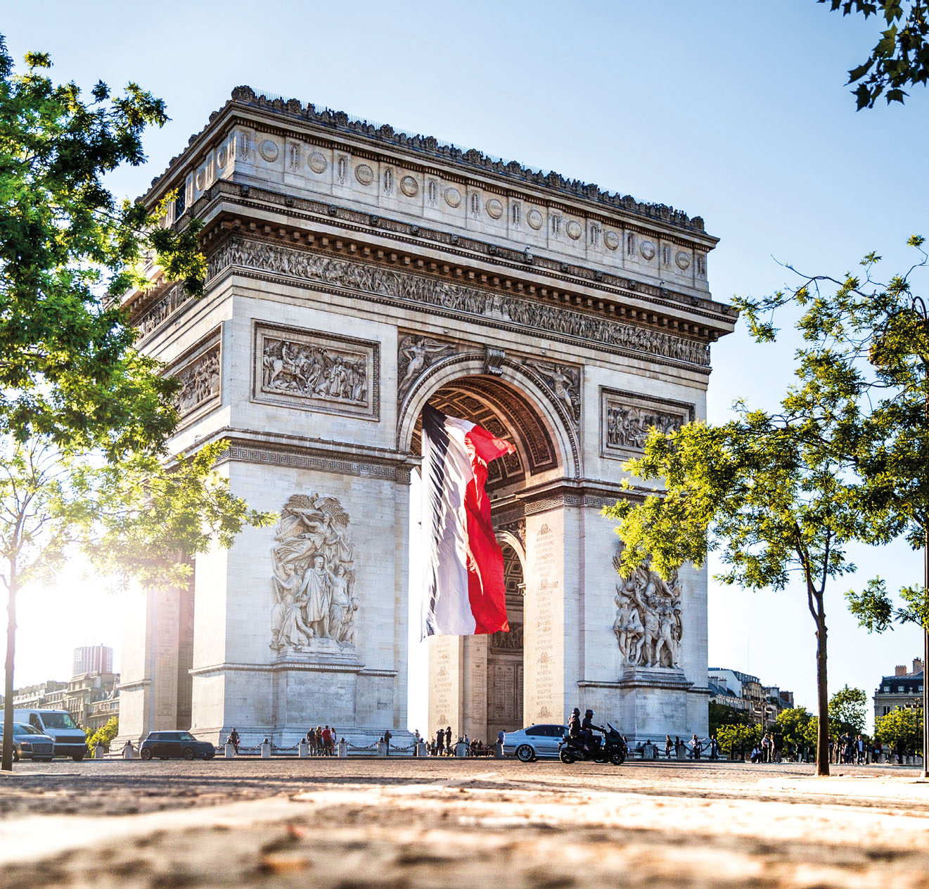 View of Paris Arc de Triomphe at night during the 14th of July, National Holiday.