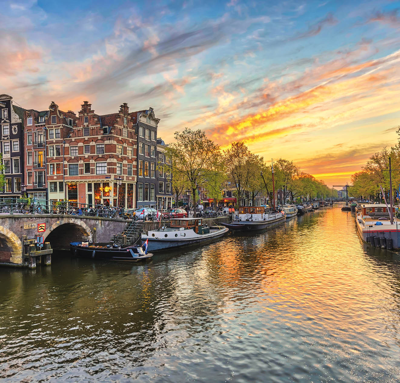 Amsterdam sunset city skyline at canal waterfront, Amsterdam, Netherlands
