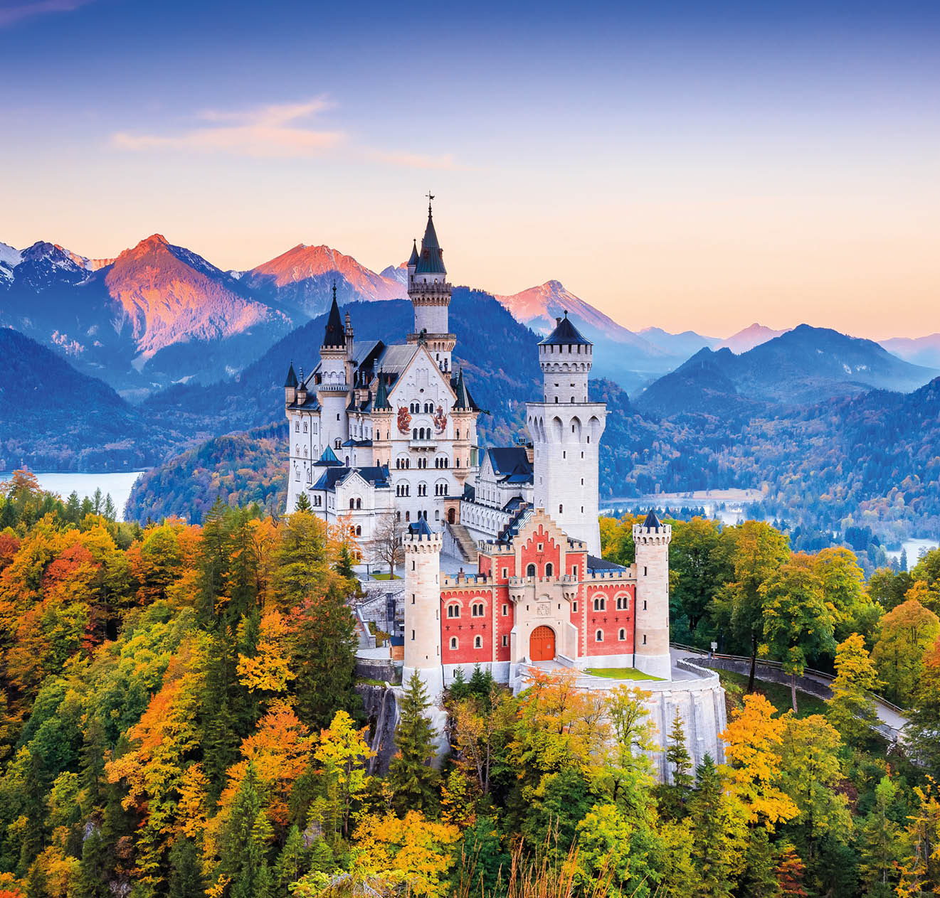 Neuschwanstein Castle (Schloss Neuschwanstein) Bavaria. Fussen, Germany. Front view of the castle at sunrise. The Bavarian Alps in the background.