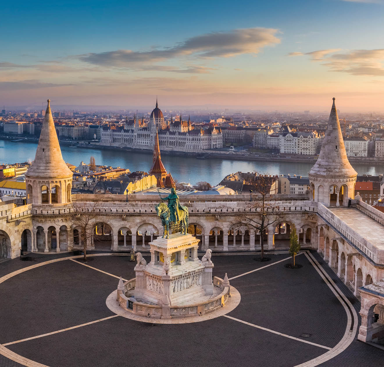 Budapest, Hungary - The famous Fisherman's Bastion at sunrise with statue of King Stephen I and Parliament of Hungary at background