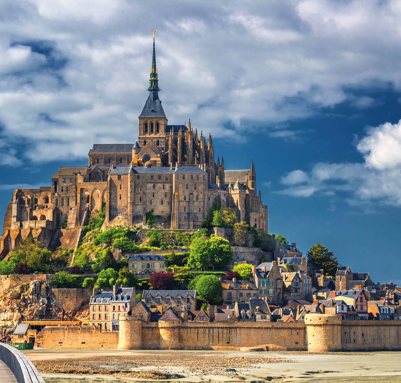 Beautiful panoramic view of famous Le Mont Saint-Michel tidal island with blue sky. Normandy, northern France