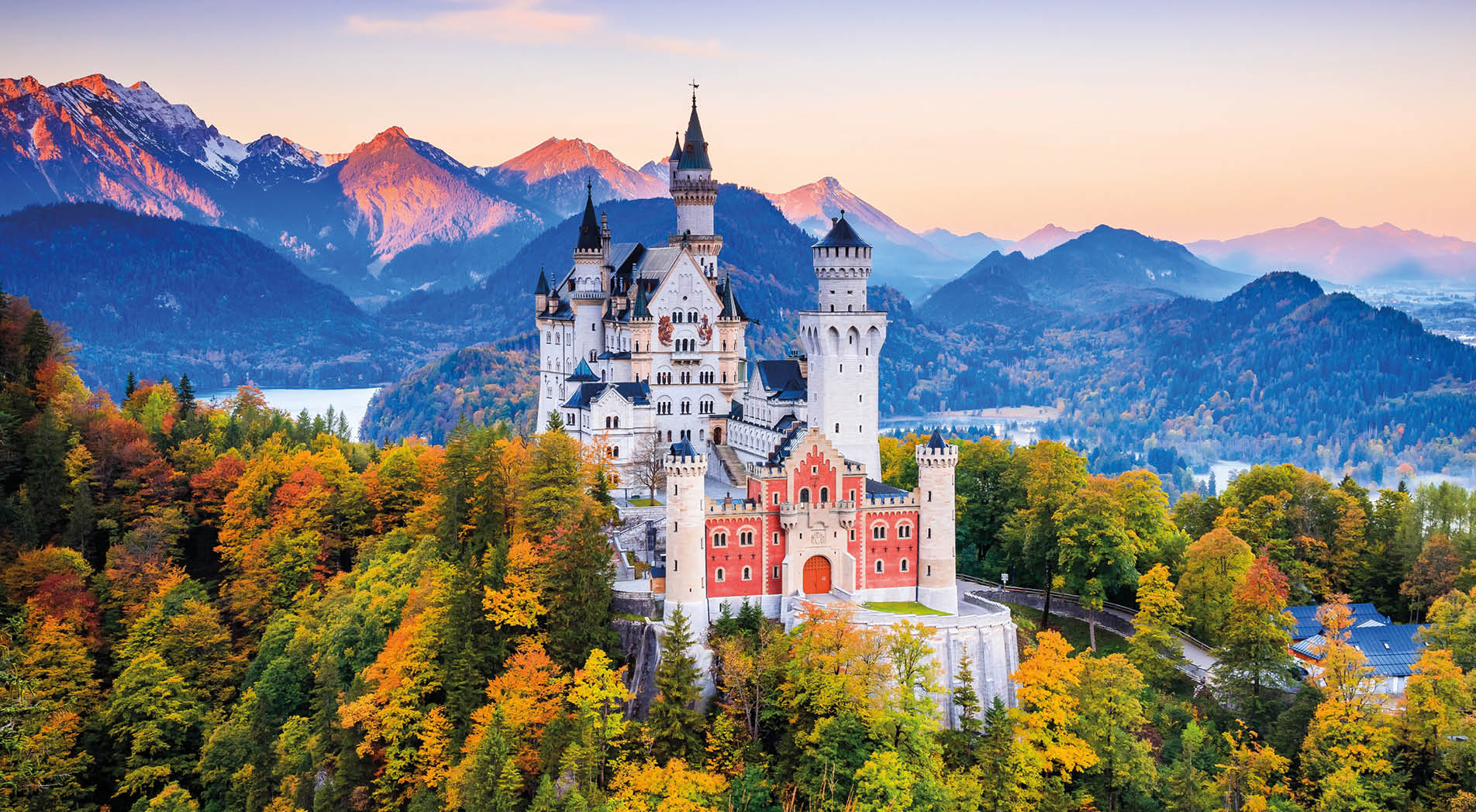 Neuschwanstein Castle (Schloss Neuschwanstein) Bavaria. Fussen, Germany. Front view of the castle at sunrise. The Bavarian Alps in the background.