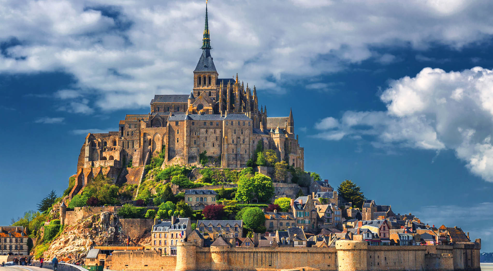 Beautiful panoramic view of famous Le Mont Saint-Michel tidal island with blue sky. Normandy, northern France