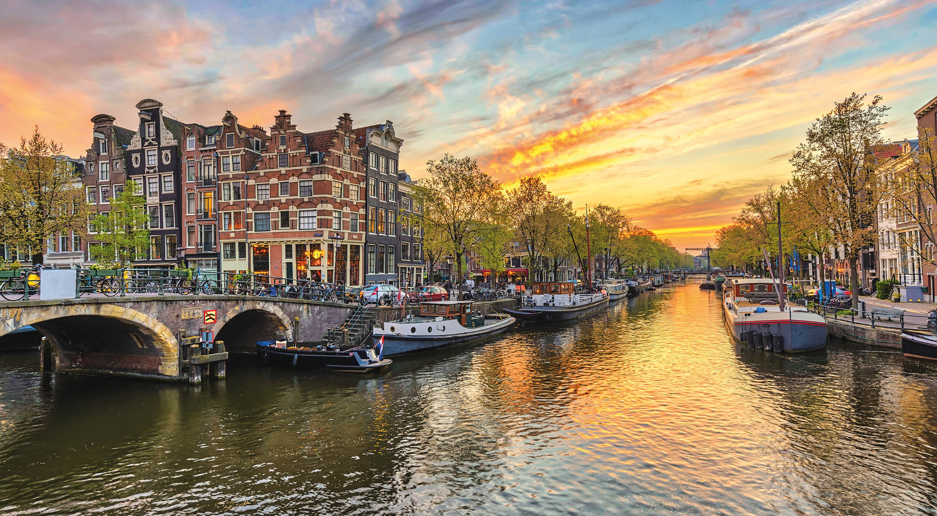 Amsterdam sunset city skyline at canal waterfront, Amsterdam, Netherlands