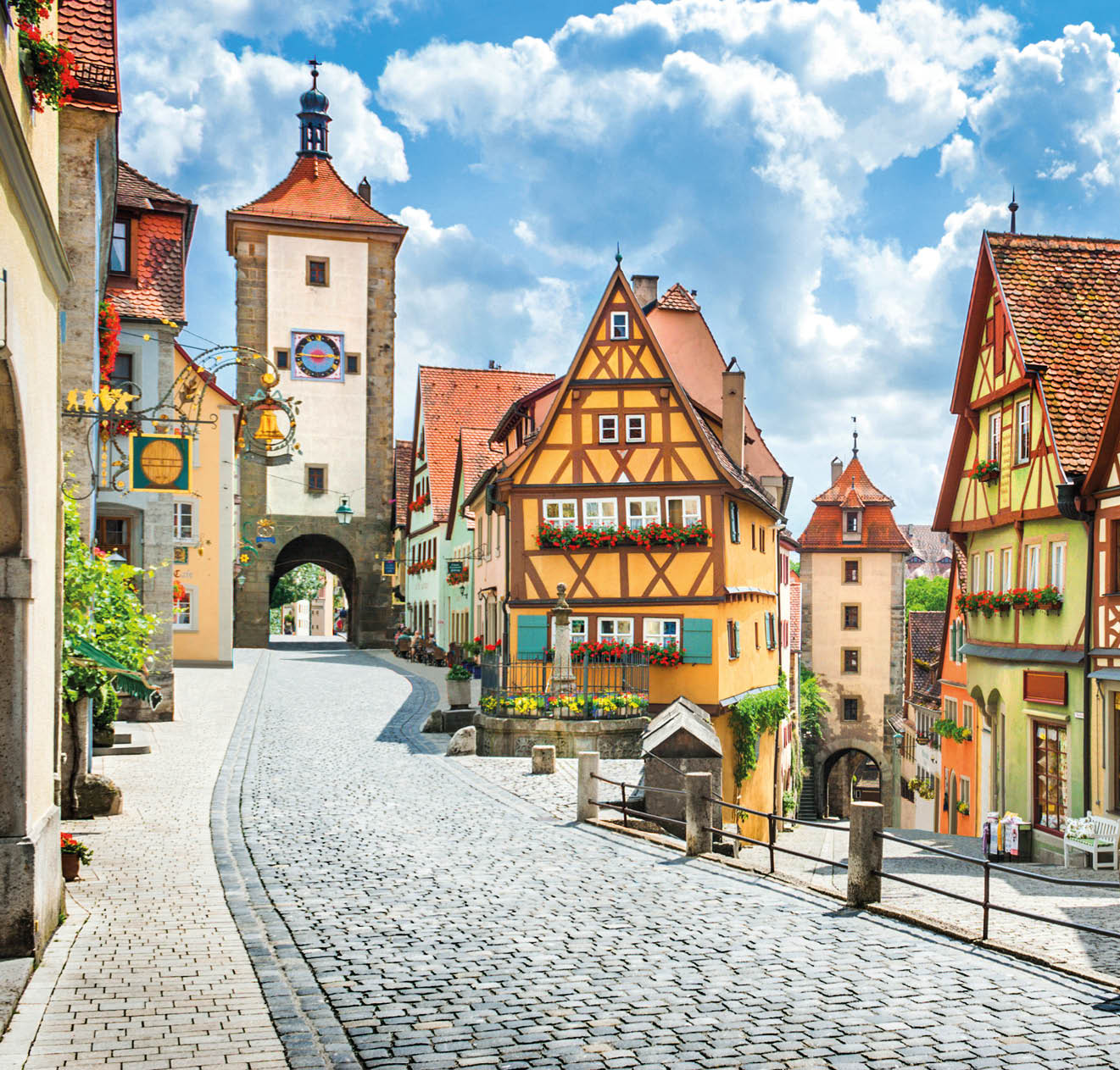 Beautiful postcard view of the famous historic town of Rothenburg ob der Tauber on a sunny day with blue sky and clouds in summer, Franconia, Bavaria, Germany