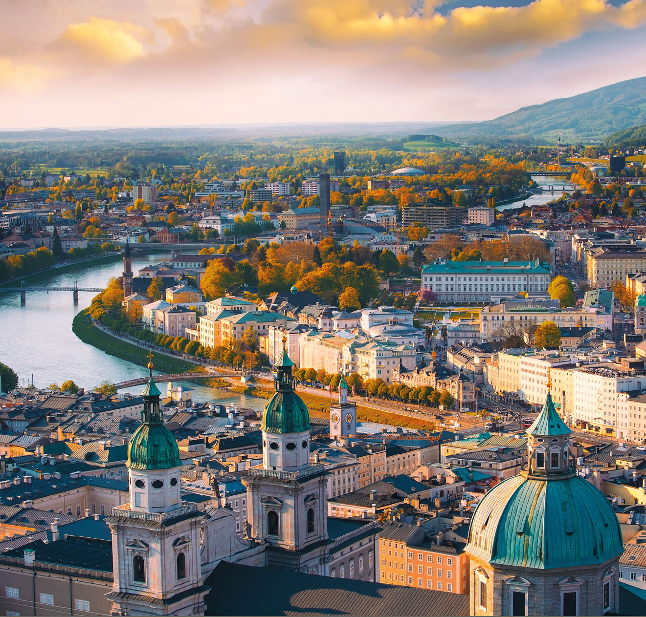 Beautiful of Aerial panoramic view in a Autumn season at a historic city of Salzburg with Salzach river in beautiful golden evening light sky and colorful of autumn at sunset, Salzburger Land, Austria