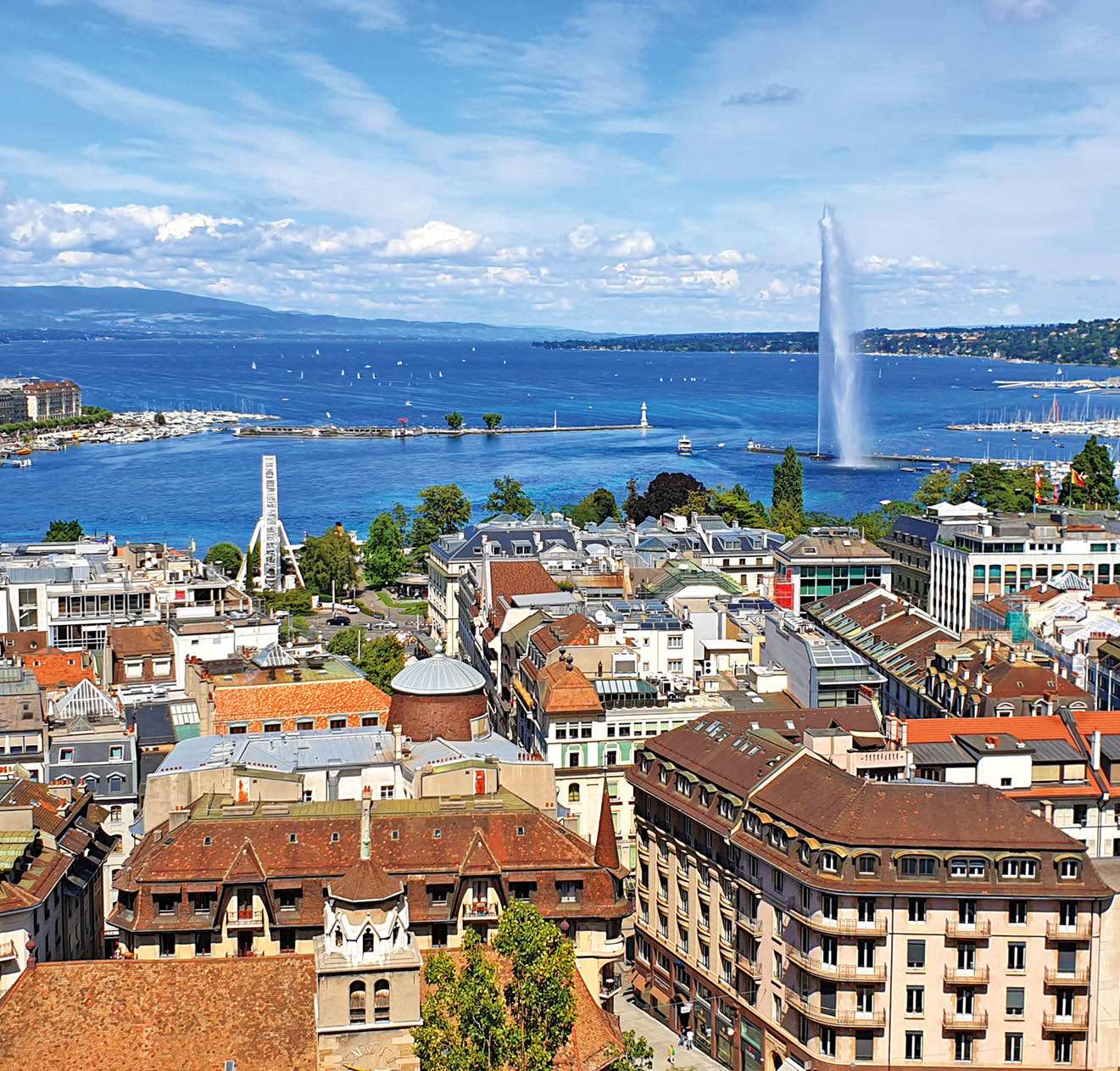 Aerial view of Geneva, Lake Geneva with famous fountain. Photo taken from Geneve Cathedral.