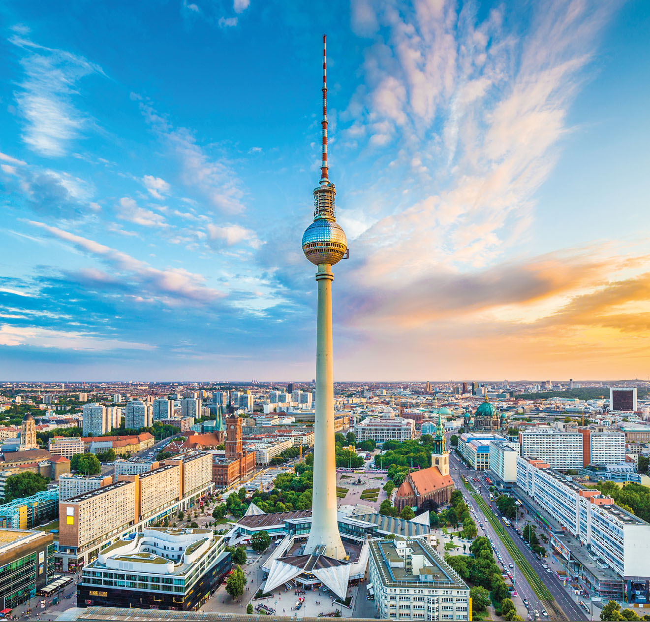 Berlin skyline panorama with famous TV tower at Alexanderplatz and dramatic cloudscape at sunset, Germany.