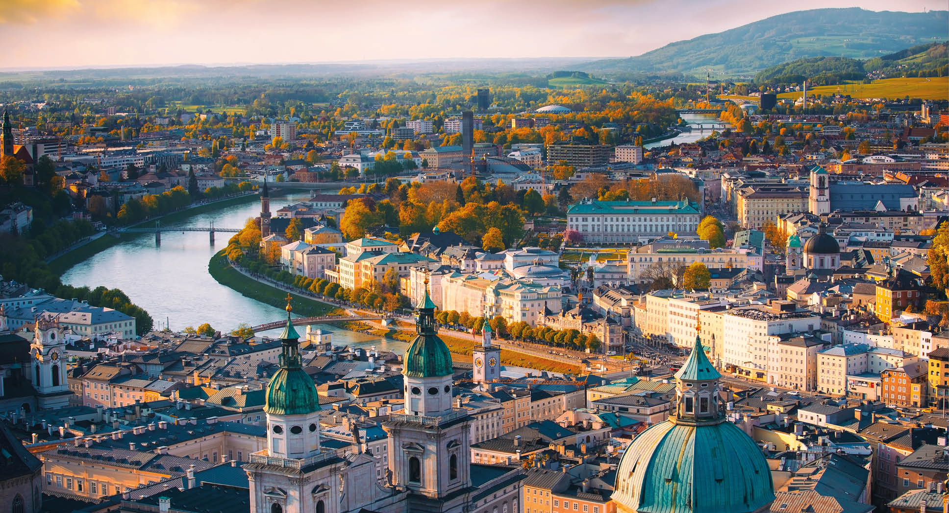 Beautiful of Aerial panoramic view in a Autumn season at a historic city of Salzburg with Salzach river in beautiful golden evening light sky and colorful of autumn at sunset, Salzburger Land, Austria
