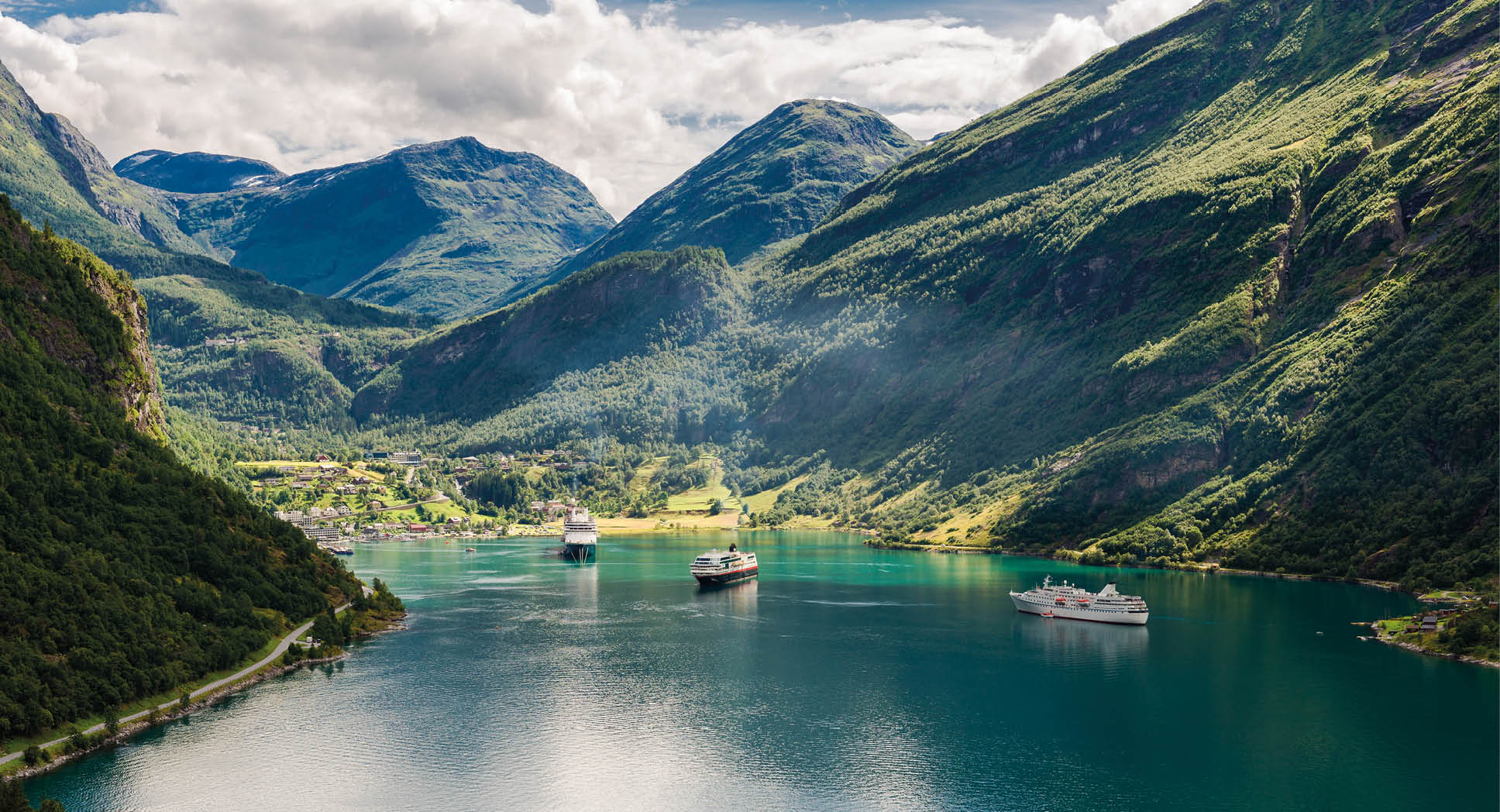 two big ships in famous Geirangerfjord in Norway between steep mountains.