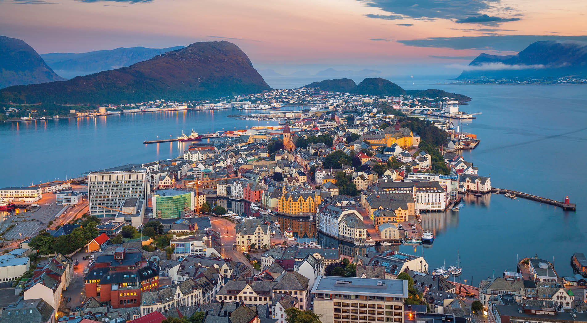 Cityscape image of Alesund, Norway at dawn.