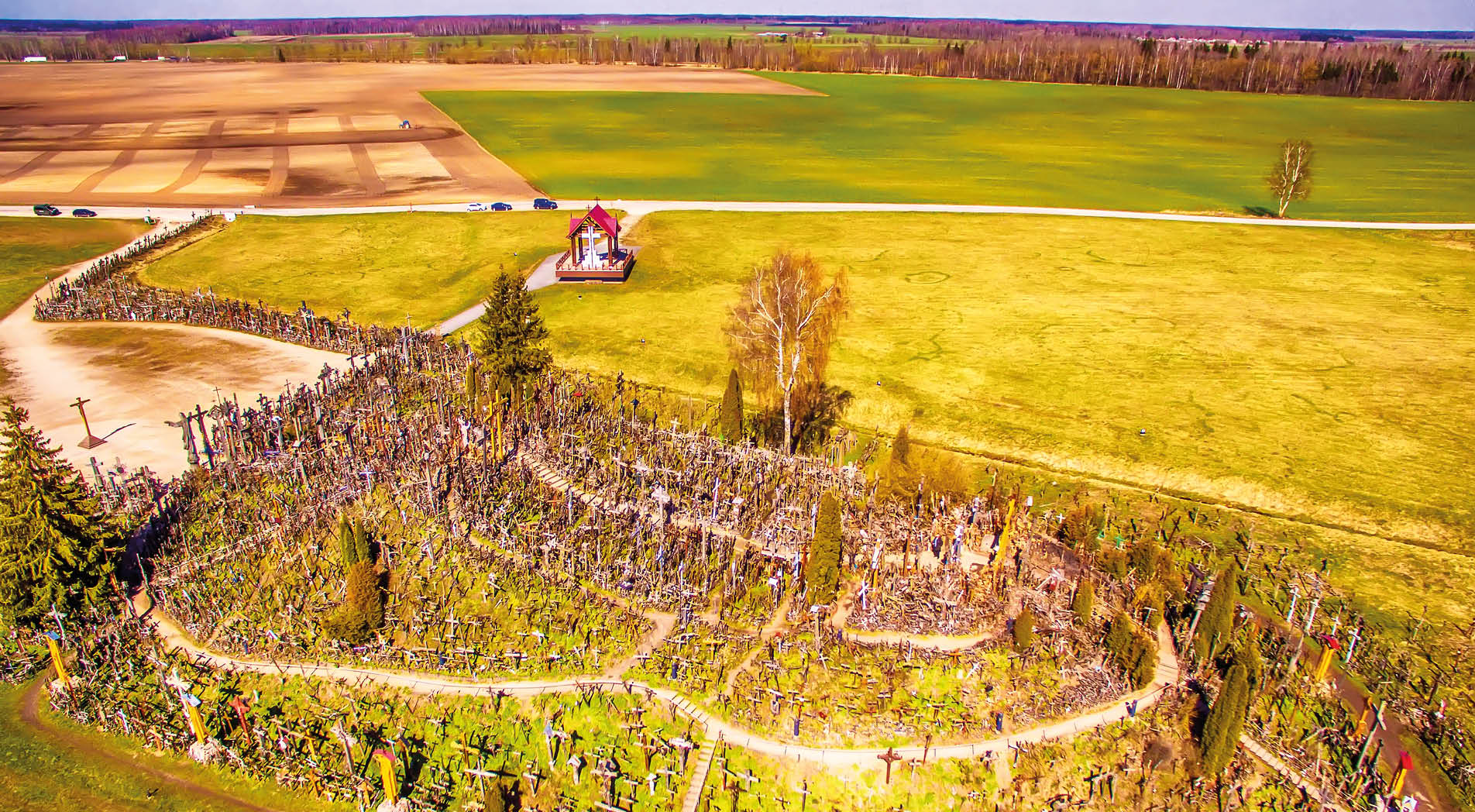 Siauliai region, Lithuania: aerial above view of Hill of Crosses in the spring. It is a famous religious site of catholic pilgrimage in Lithuania. Beautiful touristic destination in Baltic states.