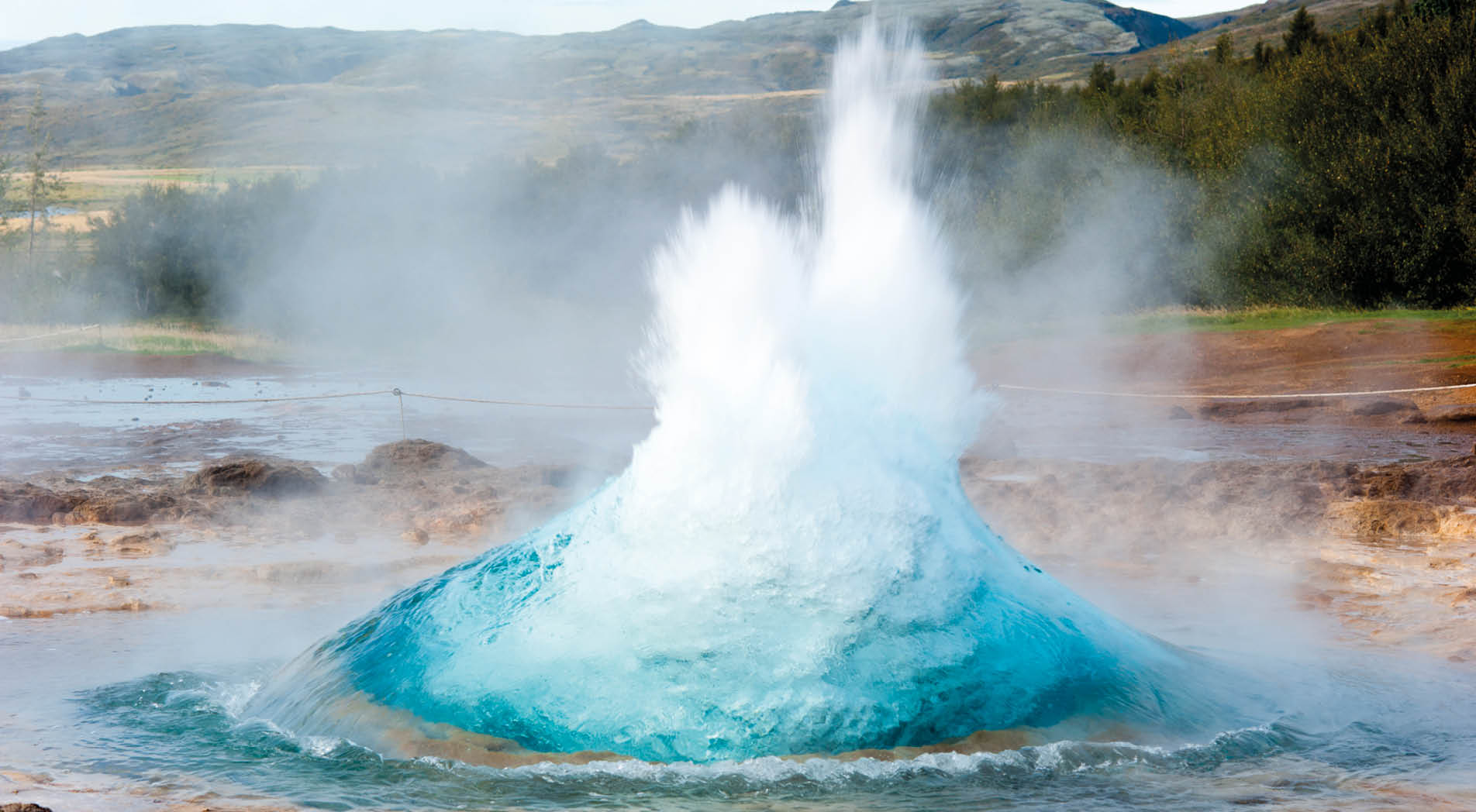 detail shot of hot spring strokkur on iceland in the first second of eruption; geothermal region in the golden circle (Gullfoss, Thingvellir, Geysir) of iceland