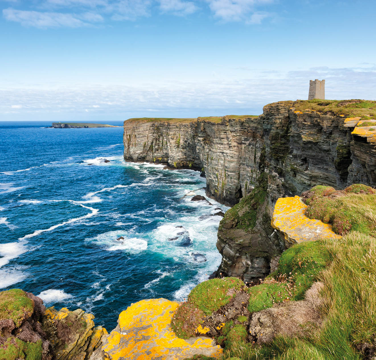 The Kitchner Memorial tower on the cliffs at Marwick Head on the west coast of the Orkney Mainland in the Orkney Islands off the northeast of Scotland. The high cliffs of Marwick Head, around 300 feet or 100 metres in height, are an important breeding ground for sea birds. The Kitchner Memorial tower was unveiled in 1926 to commemorate Lord Kitchner, British Minister of War, and the crew of HMS Hampshire who died here in 1916 during the First World War when the ship hit a mine.