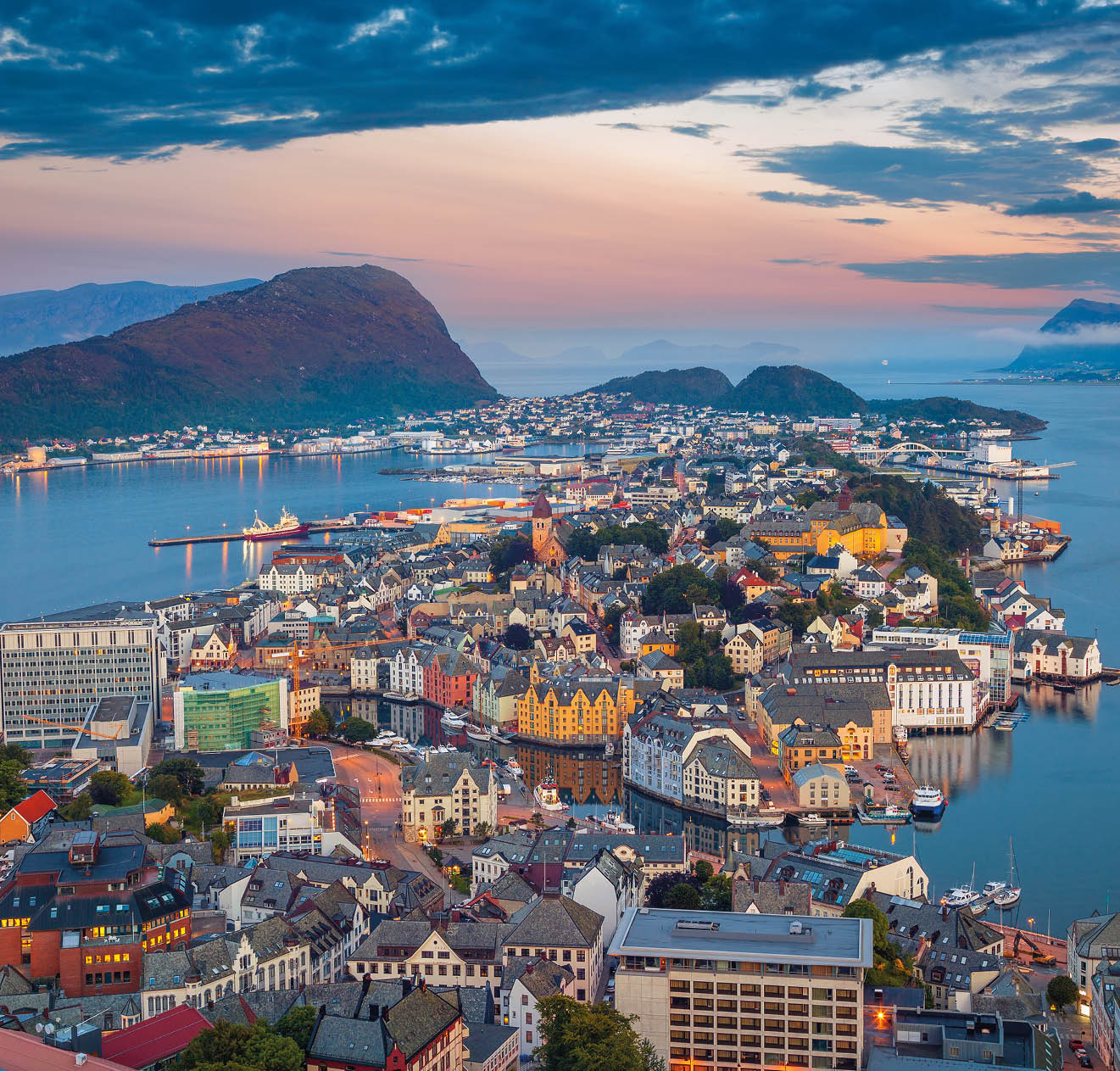 Cityscape image of Alesund, Norway at dawn.