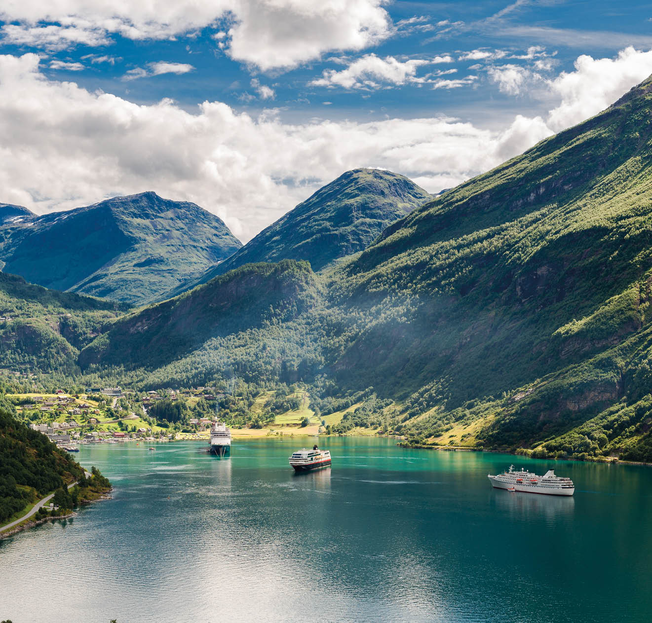 two big ships in famous Geirangerfjord in Norway between steep mountains.