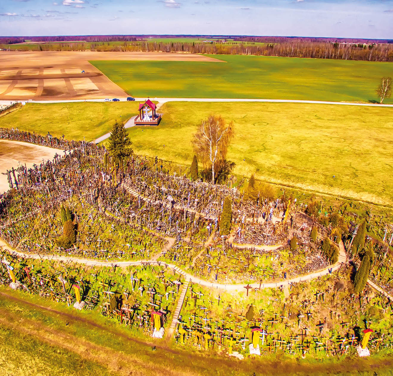 Siauliai region, Lithuania: aerial above view of Hill of Crosses in the spring. It is a famous religious site of catholic pilgrimage in Lithuania. Beautiful touristic destination in Baltic states.