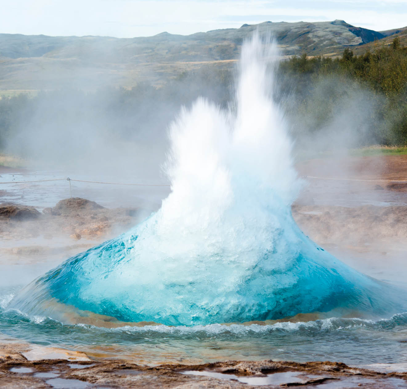 detail shot of hot spring strokkur on iceland in the first second of eruption; geothermal region in the golden circle (Gullfoss, Thingvellir, Geysir) of iceland