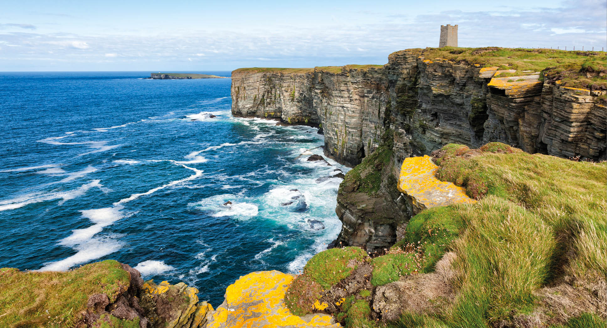 The Kitchner Memorial tower on the cliffs at Marwick Head on the west coast of the Orkney Mainland in the Orkney Islands off the northeast of Scotland. The high cliffs of Marwick Head, around 300 feet or 100 metres in height, are an important breeding ground for sea birds. The Kitchner Memorial tower was unveiled in 1926 to commemorate Lord Kitchner, British Minister of War, and the crew of HMS Hampshire who died here in 1916 during the First World War when the ship hit a mine.