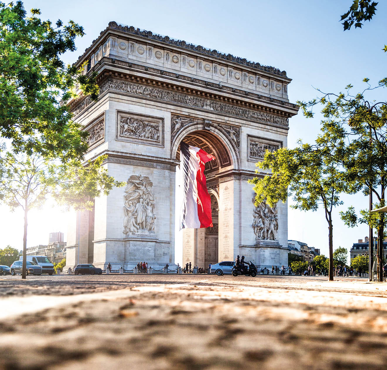 View of Paris Arc de Triomphe at night during the 14th of July, National Holiday.