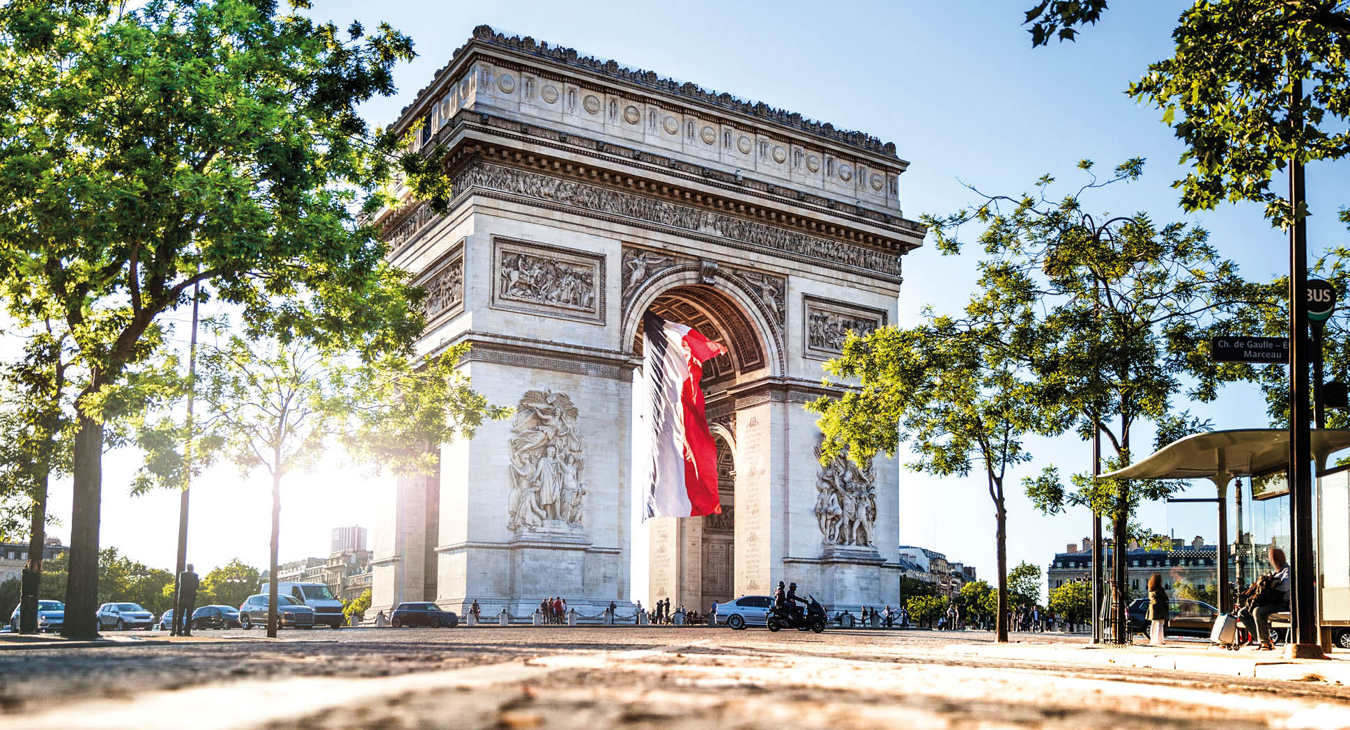 View of Paris Arc de Triomphe at night during the 14th of July, National Holiday.